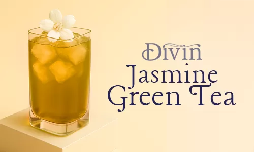 A refreshing glass of iced jasmine green tea in a rectangular glass, topped with a delicate jasmine flower, placed on a beige podium with a soft warm background.