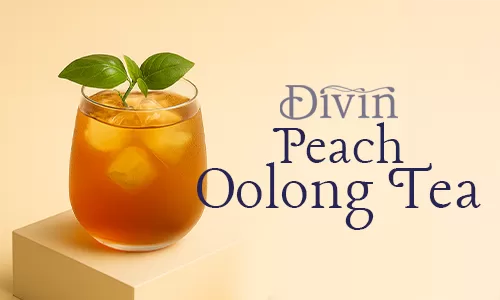 A glass of iced peach oolong tea with fresh leaves on top, placed on a podium with a peach slice nearby, styled against a warm beige background.