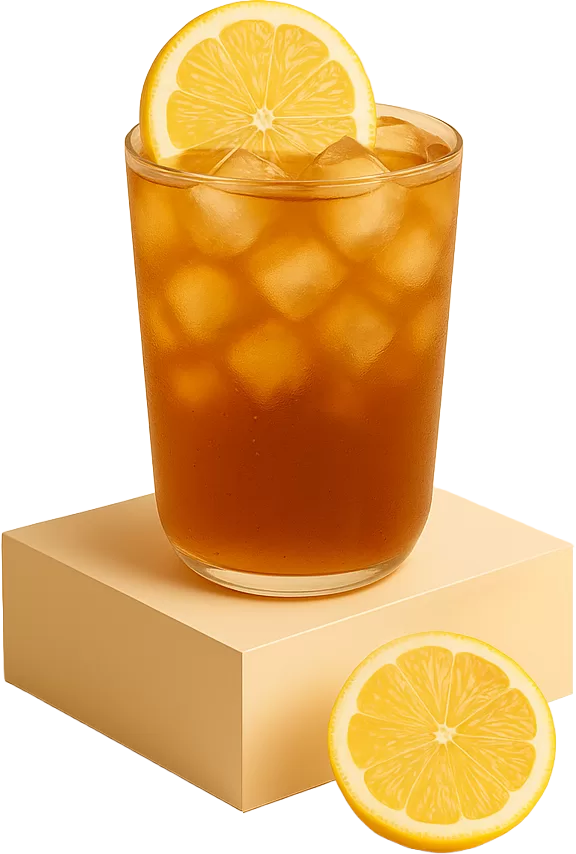 a glass of iced honey lemon green tea on a podium with ice cubes, a lemon slice on top, and half a lemon beside it
