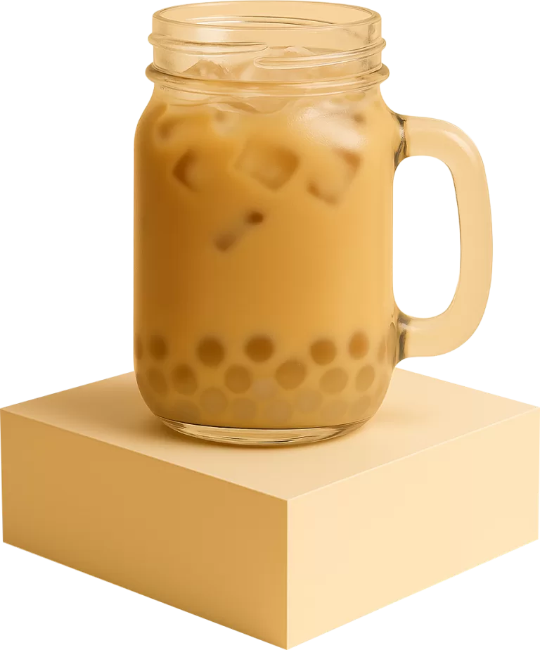 a mason jar filled with iced classic milk tea and lychee popping boba at the bottom, placed on a beige podium with a plain background